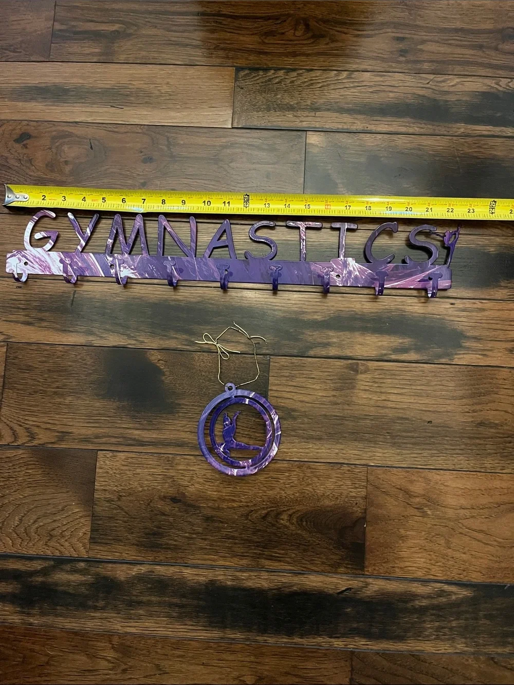 Purple Gymnastics Metal Medal Hanger Set with gymnastics figure ornament.